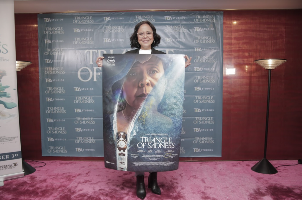 Dolly de Leon signs the official poster two of Triangle of Sadness. Designed by Justin Besaña.